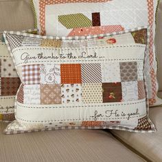 two decorative pillows on a couch with the words give thanks to the lord printed on them