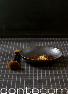 a bowl and brush sitting on the ground