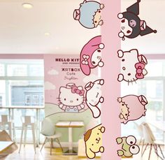 there are many hello kitty stickers on the glass wall in this office building,