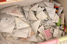 a box filled with lots of writing and papers