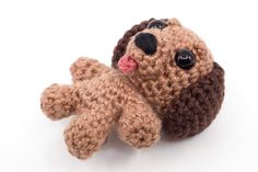 a crocheted stuffed dog laying on its side