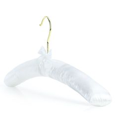 a white banana shaped object hanging from a gold hook on a white background with clippings