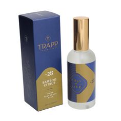 a bottle of trapp perfume next to a box on a white background with a gold cap