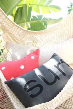 two black and red pillows sitting on top of a hammock