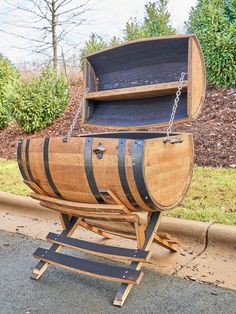 a large wooden barrel sitting on top of a metal stand