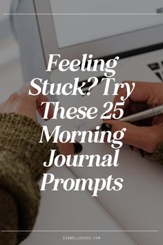 someone writing on a notebook with the words feeling stuck? try these 25 morning journal prompts