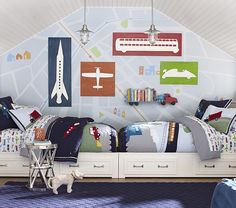 a child's bedroom decorated in blue, green and white with airplanes on the wall