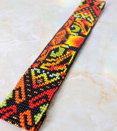 a colorful beaded tie sitting on top of a table