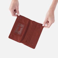 The wallet that inspired the Lumen Collection, this bifold wallet is the perfect balance of function and style. Lumen Continental Wallet In Pebbled Leather  Rust LARGE WALLET in Rust | Hobo® Leather Clutch Wallet, Large Wallet, Crossbody Wallet, Small Pouches, Handbag Straps, Eyeglass Case, Bifold Wallet, Leather Tassel, Wallet Bag