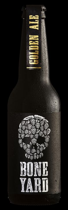 a bottle of bone yard beer on a black background with the words bone yard printed on it