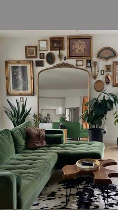 a living room filled with furniture and lots of pictures on the wall above it's mirror