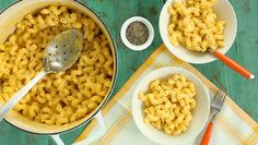 two bowls filled with macaroni and cheese on top of a table