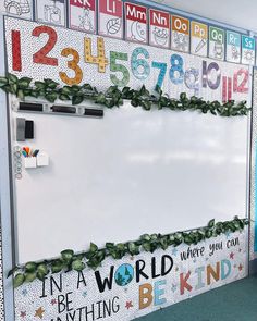 a bulletin board decorated with letters and numbers on it's sides, along with plants