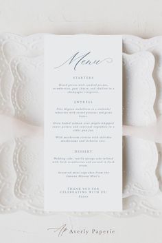 the menu card is displayed on top of a white platter with lace trimming