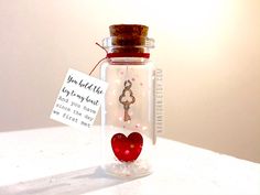 a glass bottle with a key inside and a tag attached to the top that says you are not the key to my heart