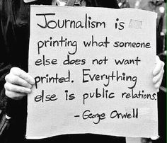 a person holding a sign that says, journalist is printing what someone else does not want printed everything else is public relations