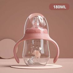 a pink baby bottle with an elephant inside