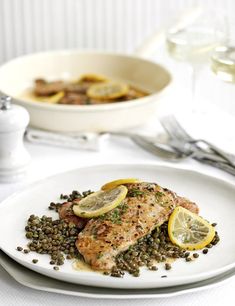 a white plate topped with fish and lentils