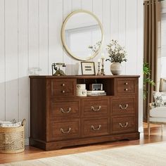 a wooden dresser with drawers and a mirror on top of it in a living room