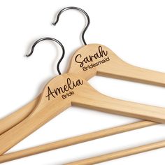 two wooden clothes hangers with names on them