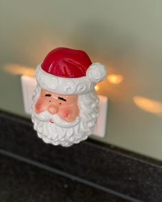 a santa clause head is hanging on the wall