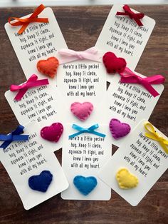 four cards with different colored hearts on them and some words written in white paper next to each other