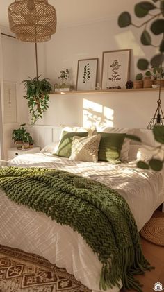 a bed with green and white blankets in a bedroom next to a plant filled wall