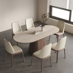 a dining table with chairs around it in front of a window and a potted plant