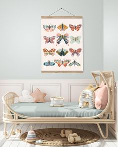 a baby's room with a crib and butterfly art on the wall above it