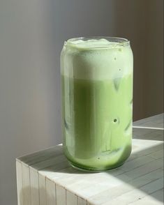 a green drink sitting on top of a counter