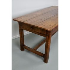 a wooden table sitting on top of a gray floor