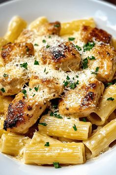 pasta with chicken and parmesan cheese in a white bowl