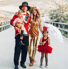 a man and two children are dressed up as nutcrackers with an umbrella