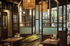 the interior of a restaurant with wooden tables and chairs