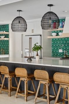 a large kitchen with lots of counter space and stools in front of the island