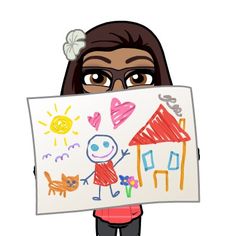 a woman holding up a drawing with cats and houses on it