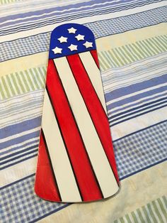 an american flag shaped cutting board sitting on top of a tablecloth covered table cloth