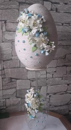 the vase is decorated with flowers and pearls