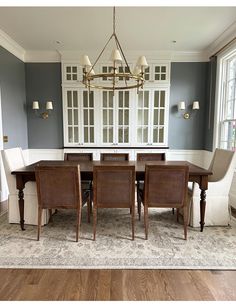 a dining room table with chairs and a chandelier