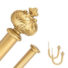 a golden door handle and hook on a white background