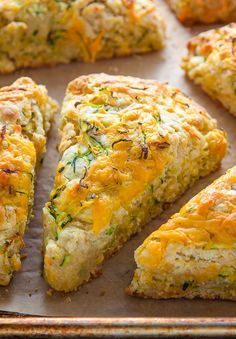 several pieces of quiche sitting on top of a baking sheet