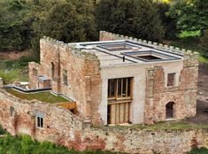 an old brick building with a green roof