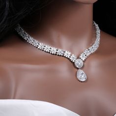 "Gorgeous crystal bridal jewelry set for your wedding day: necklace, bracelet and earrings.  This wedding jewelry set is available in silver color.  Necklace measures about 17 1/2\" long.  Earrings are about 1 3/4\" long and 3/4\" wide. Matching regular bracelet is measuring: 7\" long and 1/2\" wide or an adjustable bolo matching bracelet is available as well, Just contact me. High quality guaranteed by Latasha Bridal!" Silver Crystal Bridal Sets For Anniversary, Silver Crystal Jewelry Sets For Brides, Silver Crystal Jewelry Sets With Elegant Design, Bride's Silver Crystal Jewelry Sets, Silver Bridal Necklace With Elegant Cubic Zirconia Design, Silver Bridal Necklace With Cubic Zirconia, Silver Teardrop Jewelry Sets With Elegant Design, White Cubic Zirconia Bridal Jewelry, Silver Crystal Bridal Sets