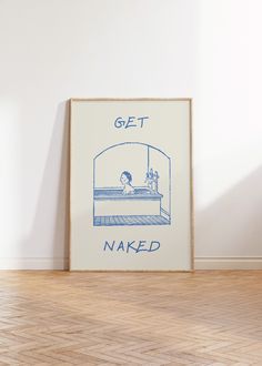 a blue and white poster with the words get naked on it in front of a wooden floor