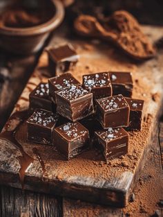 a pile of chocolate pieces sitting on top of a wooden cutting board