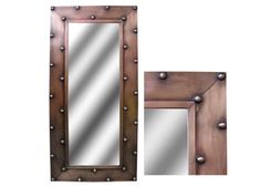 a wooden mirror with metal rivets on it