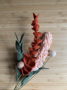 a close up of a flower on a wooden surface