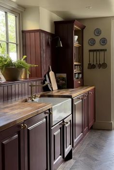 a kitchen with brown cabinets and wooden counter tops