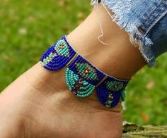 a woman's foot wearing a blue beaded bracelet