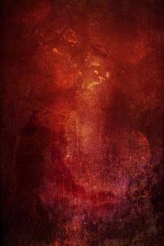 an abstract painting with red and yellow colors on the wall in front of a dark background